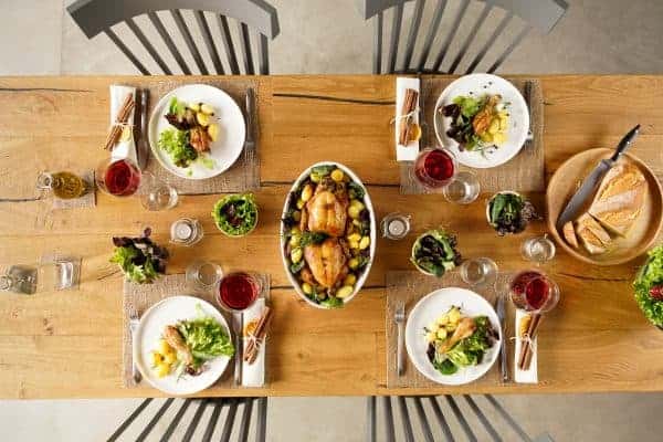 Roast Chicken ready on a table with glasses of wine - Inspiring Wines