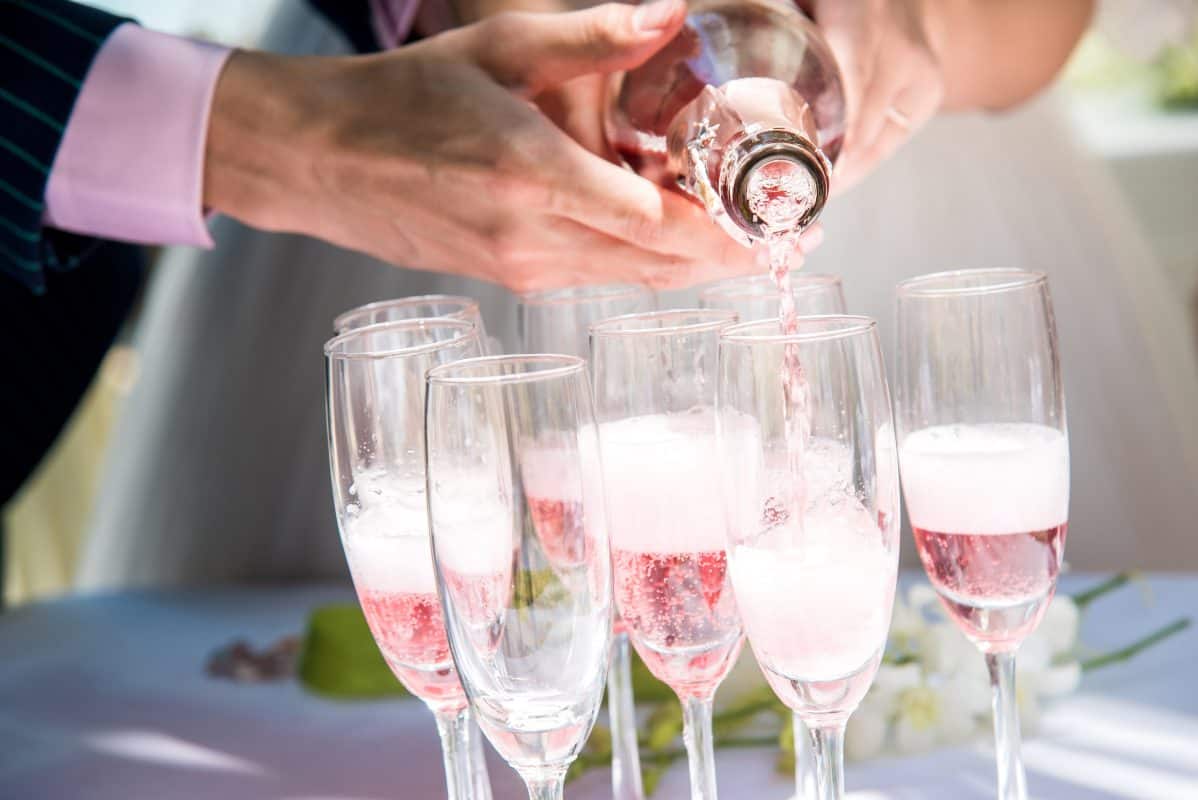 Pouring pink Champagne at a wedding - Wedding wine from Inspiring Wines